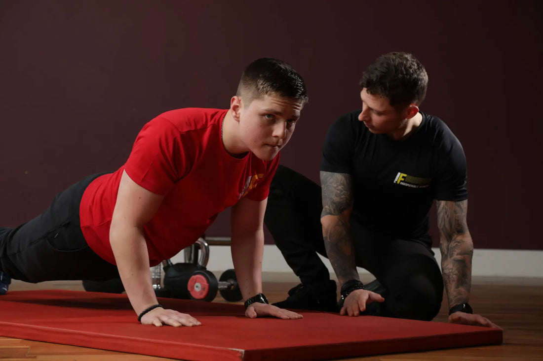 Two men performing bodyweight exercises to build strength during their fitness journey