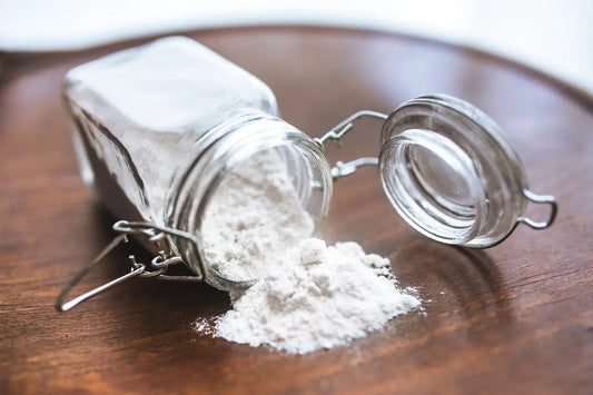Glass jar with white powder symbolizing gluten-free diet and celiac disease awareness