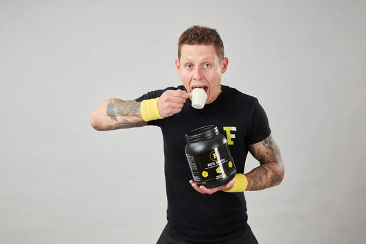 Man eating protein powder during carb loaded workouts for optimal fitness results