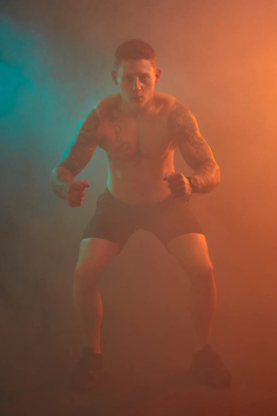 Shirtless muscular man in shorts demonstrating functional fitness for real-life benefits