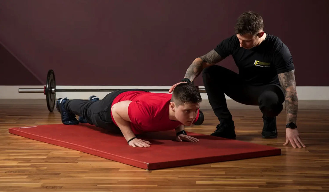 Man doing push-ups with trainer for better posture and reducing back pain
