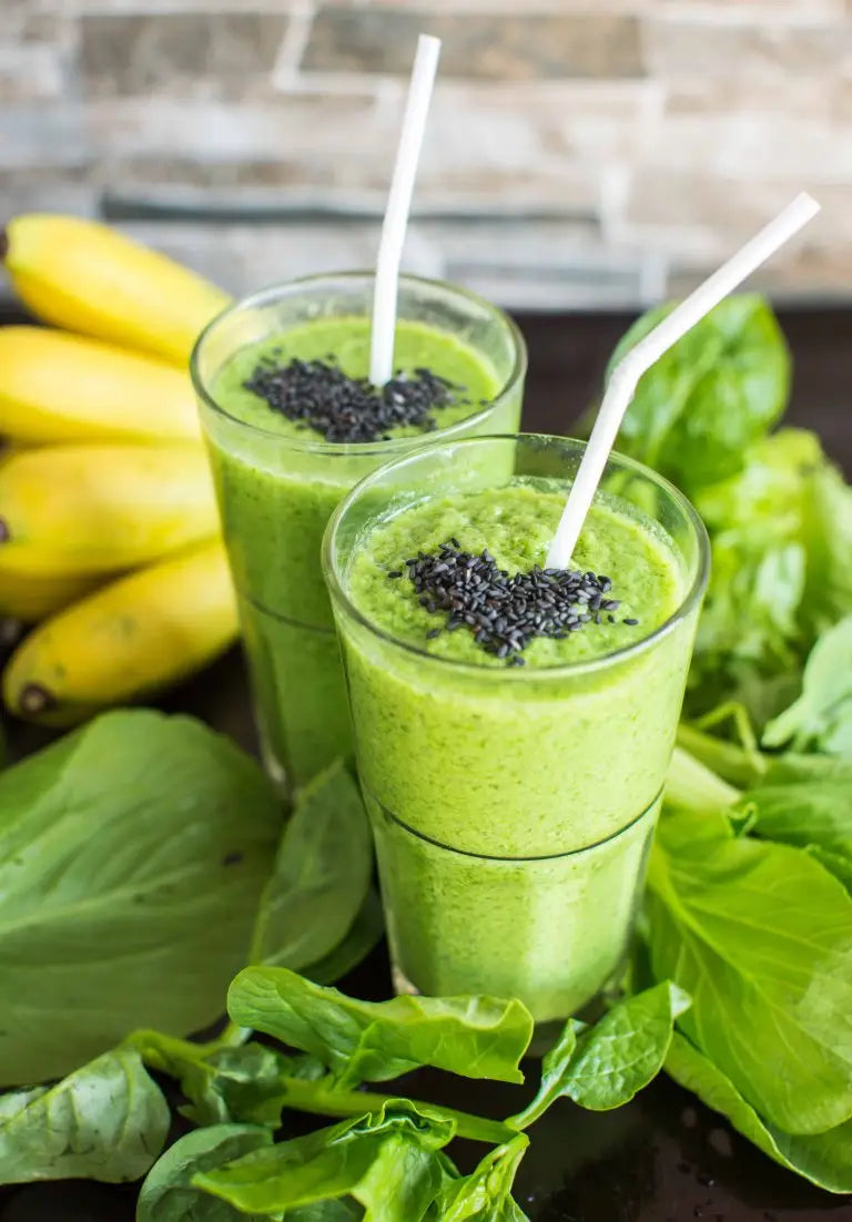 Two vibrant green smoothies made with super greens that can boost your health