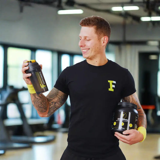 Man smiling while holding water bottle in TRAIN DIFFERENT Black Tee Perfect T-Shirt